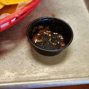 The plastic bowl for salsa.