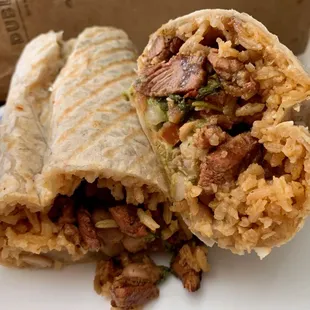 Super Burrito with Al Pastor, Rice, Pinto Beans, Cheese, Pico de Gallo, Sour Cream, and Guacamole