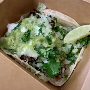 Super Taco with Carnitas, Onion, Cilantro, Green Salsa, Cheese, Guacamole, and Sour Cream