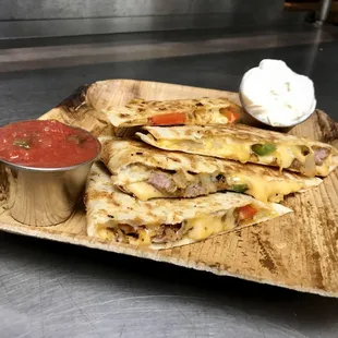 a plate of quesadillas and salsa