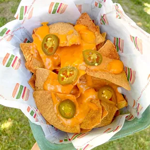 Patchos! Our vegan nachos with our handcrafted dairy-free spicy cheese sauce and jalapenos. Customize with add-ons!