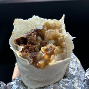 Inside my "double gringo Breakfast Burrito" Chorizo's &amp; bacon  egg &amp; potatoes green chili sauce.  4/10