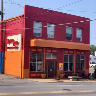 a red building with a yellow awning