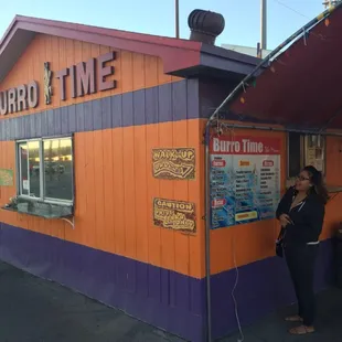 a woman standing in front of a restaurant