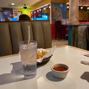 a glass of water and a bowl of chili