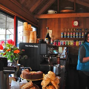 a woman standing in front of a coffee machine