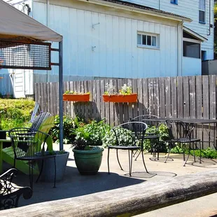 a patio area with tables and chairs