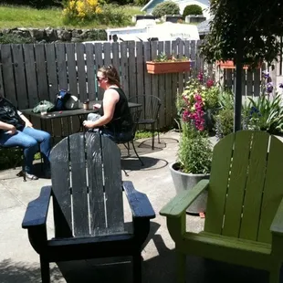 two people sitting outside in chairs