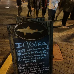 a chalkboard sign on a sidewalk