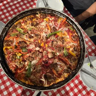 Deep dish pizza. Peppers, onion, and sausage