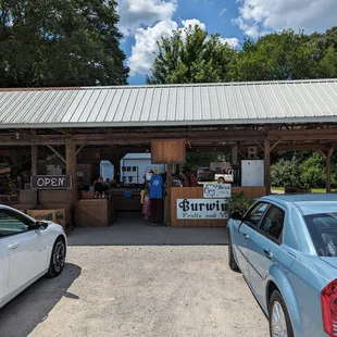two cars parked in front of a store
