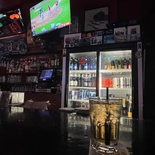 a bar with several televisions on the wall