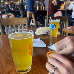 a person sitting at a table with a glass of beer