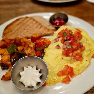 Oxaca omelette with home fries + toast. Delicious and filling !