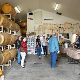 a group of people standing in a wine cellar