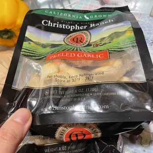 a hand holding a bag of chopped garlic
