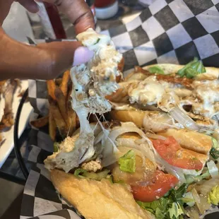 Very small amount of chicken on top of sub , set up to deceive the customer- loaded with toppings in the bottom of the sub roll