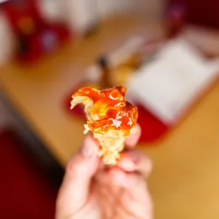 a person holding a piece of food