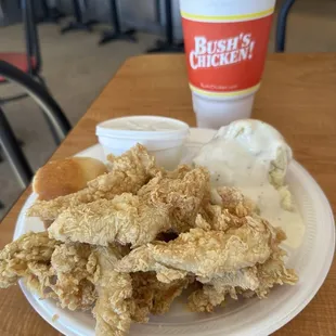 a plate of fried chicken and a cup of ice cream