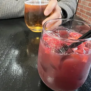 a person sitting at a table with a drink