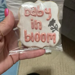 a hand holding a decorated cookie