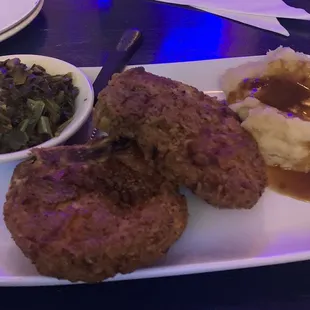 Fried bone in pork chops, collard greens and mashed potatoes with gravy. Very delicious!!