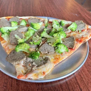 Two slice lunch special with meatball and broccoli