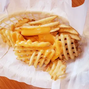 a basket of french fries and cheese