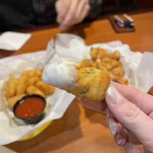 a person holding a piece of food