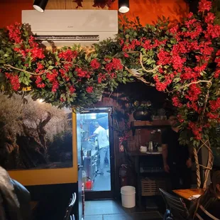 In the back room, decorations surround the kitchen door.