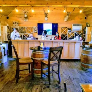 a bar with wine barrels