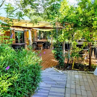 a patio with tables and chairs