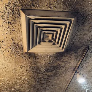 Ceiling vents at the restaurant. Black dust hanging from the ceiling.