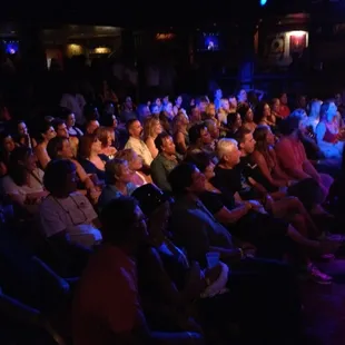 a crowd of people sitting in a theater