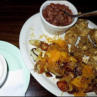 Batter fried chicken livers with cream gravy, country fried potatoes and pinto beans