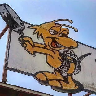 a yellow dog holding a knife