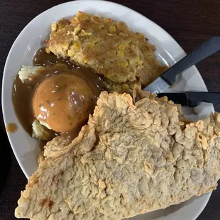 Large country fried steak with mashed potatoes and corn casserole