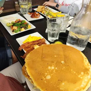 Plate size pancakes with scrambled egg &amp; bacon