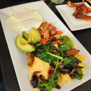Cheddar grits and eggs, served with bacon, spinach, avocado, mushrooms and pico.