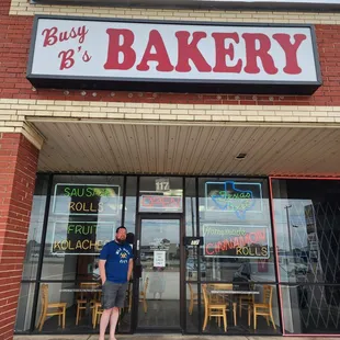 a man standing in front of a bakery
