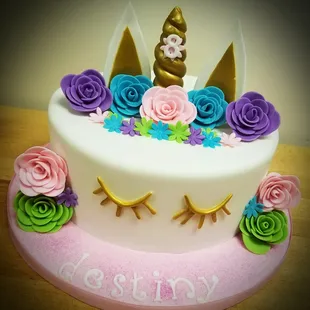a unicorn cake with flowers