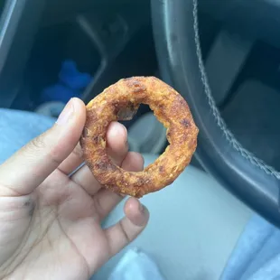 a person holding a donut in their hand