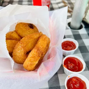 a basket of fried tater tots with ketchup