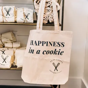 a tote bag that says happiness in a cookie