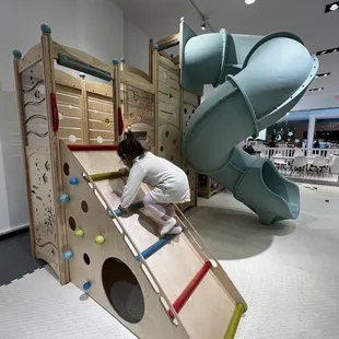 a child climbing a slide