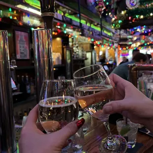 two people toasting at a bar