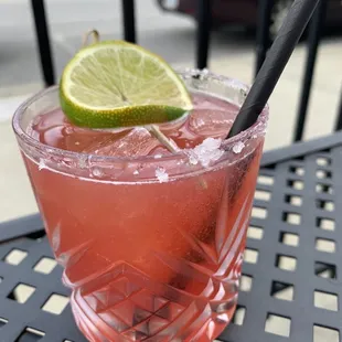 a pink drink with a lime slice