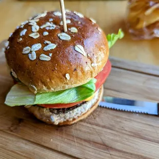 a burger on a cutting board