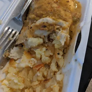 a plate of food in a styrofoam container