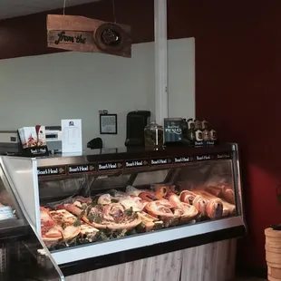 a variety of meats in a display case